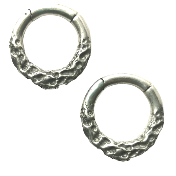 Pair of silver hoop earrings on a white background