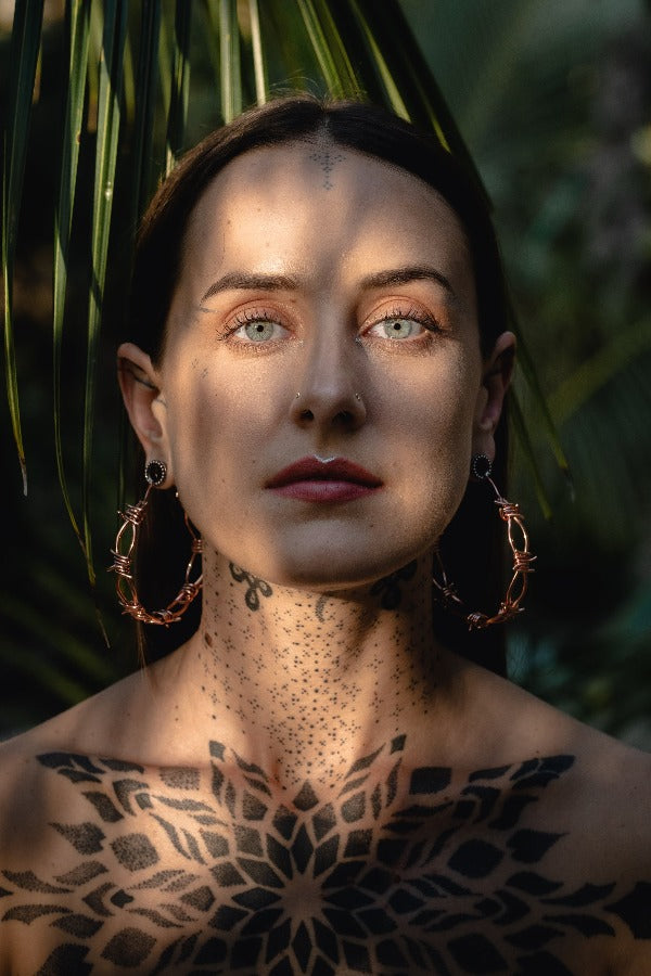 18k rose gold plated brass earrings - ear weights with barbed wire - Pua on model  wearing tunnels