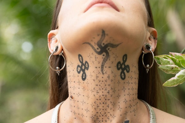 Stainless steel earrings - Triangle Dots on model wearing tunnels