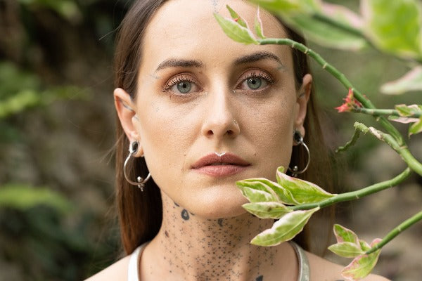 Stainless steel earrings - Triangle Dots on model wearing tunnels
