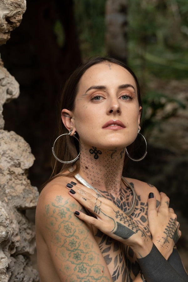 Stainless steel hoop earrings - Delicate Dotwork on model wearing tunnels