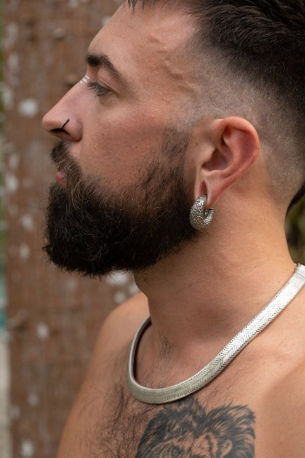 White brass clicker ear weights - Textured Infinity on model with stretched ears