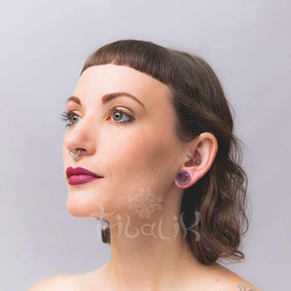 model wearing amethyst ear tunnel