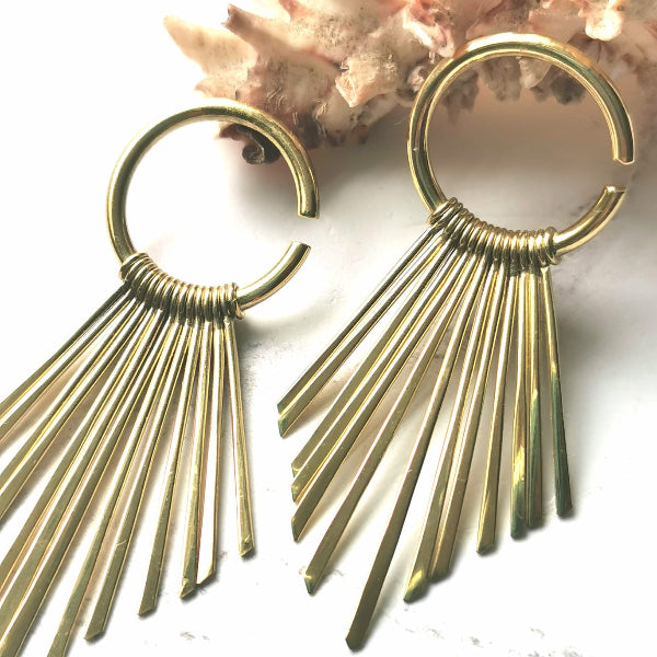 Gold fringe earrings on a white background