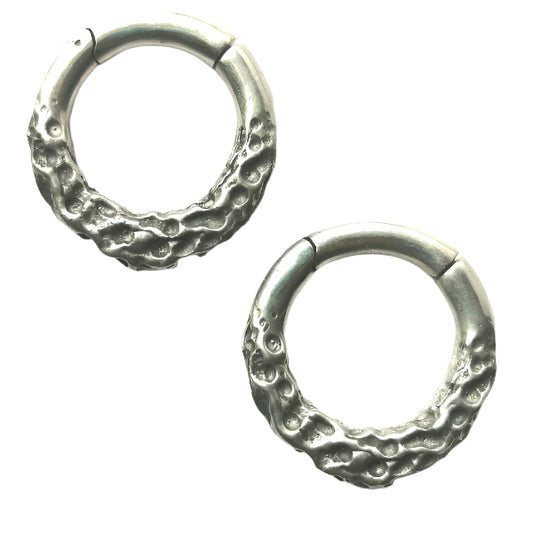 Pair of silver hoop earrings on a white background