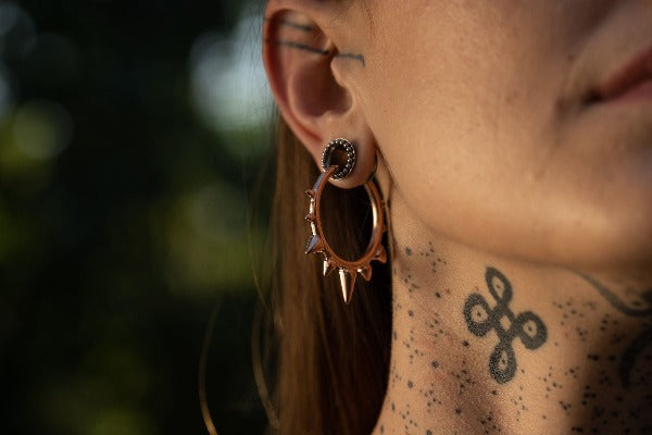 18k rose gold plated brass clicker earrings - ear weights - Ceremony with spikes on model wearing tunnels